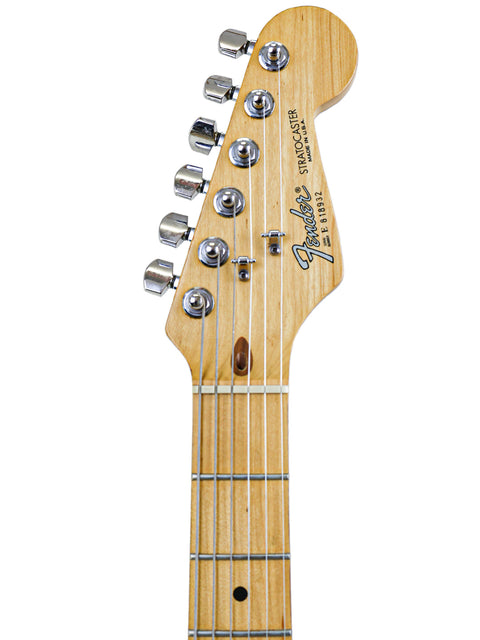Headstock and neck of a Fender Stratocaster electric guitar on a white background.