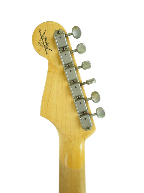 Headstock of a Fender Custom Shop '63 Michael Landau Stratocaster, captured closely with a white background.