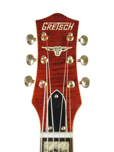 Headstock of a Gretsch Roundup 6121W Reissue electric guitar from Japan, featuring the brand name prominently displayed.
