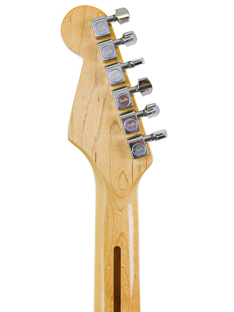 Headstock of a guitar with tuning pegs, isolated on a white background.