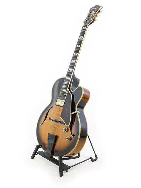 Ibanez JP20 Joe Pass Signature guitar from 1982 rests on a stand, highlighting its unique craftsmanship and vintage appeal.
