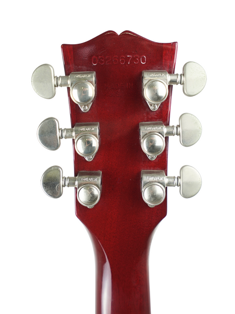 Image of a red guitar headstock with four knobs, highlighting the 2006 Gibson ES-335 Dot's design and features.