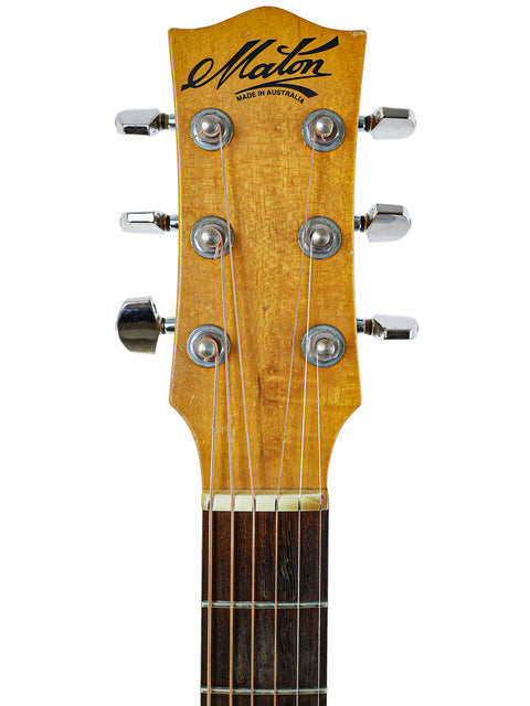 Image of the headstock from a Maton M225 acoustic guitar, crafted in Australia in 1996, showcasing its fine details.