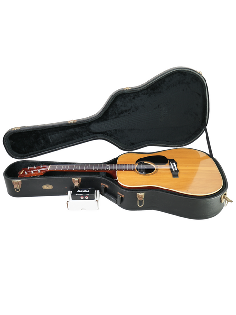 Inside a guitar case, a 1972 vintage Maton FG100 rests, highlighting its classic craftsmanship and style.