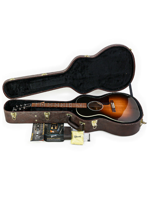 Inside a guitar case, a Gibson L-00 Standard Vintage Sunburst acoustic guitar rests, highlighting its classic beauty.