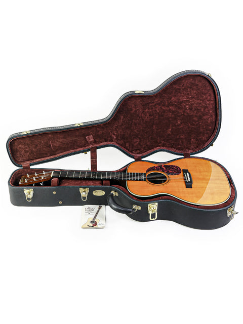 Inside a guitar case, a Martin 000-28EC Eric Clapton Signature guitar rests, highlighting its craftsmanship and style.