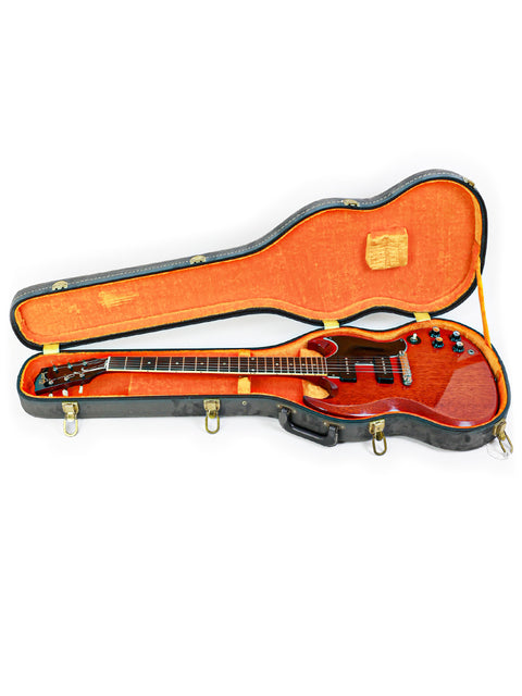 Inside a guitar case, a red vintage Gibson SG Special from 1964/5 is displayed, highlighting its timeless craftsmanship.
