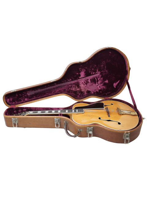 Inside a guitar case, a vintage 1939 Gibson L-5 rests, highlighting its classic craftsmanship and rich history.