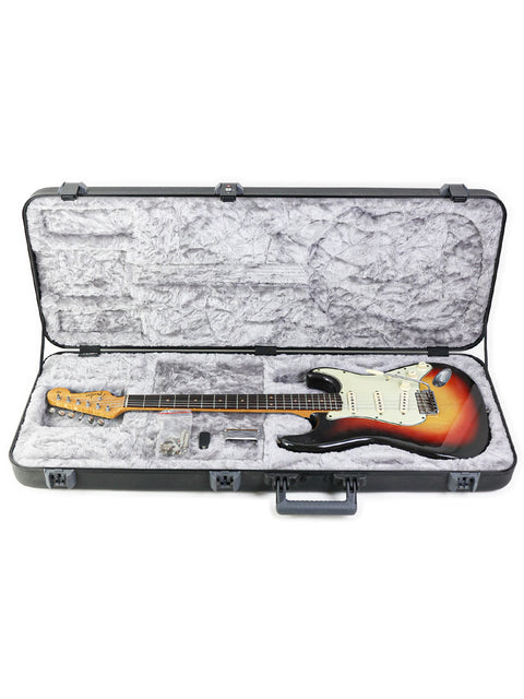  Inside a guitar case lies a 1963 vintage Fender L-Series Stratocaster, a perfect blend of history and craftsmanship.