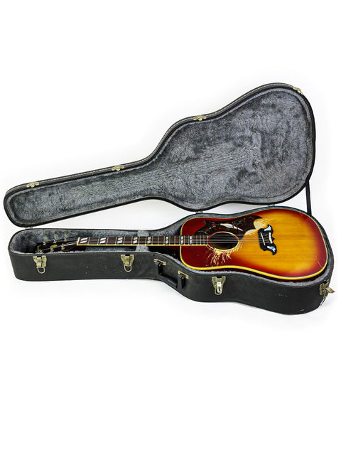 Inside a guitar case lies a 1968 vintage Gibson Dove acoustic guitar, a perfect blend of style and history.