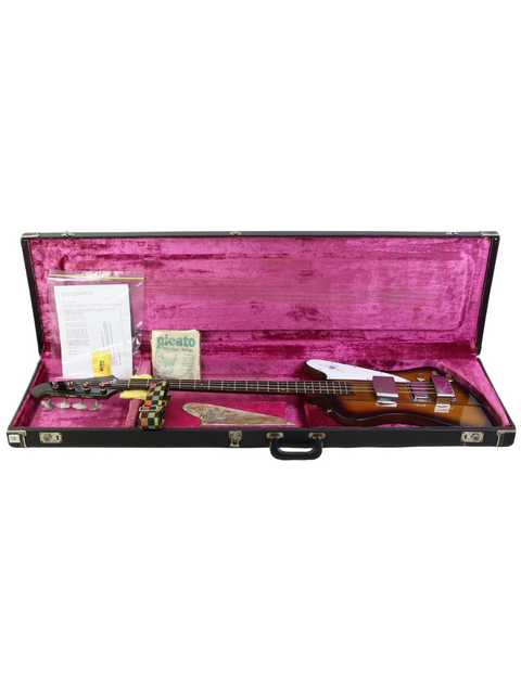 Inside a guitar case lies a 1976 vintage Gibson Bicentennial Thunderbird IV Bass, a true classic of American craftsmanship.
