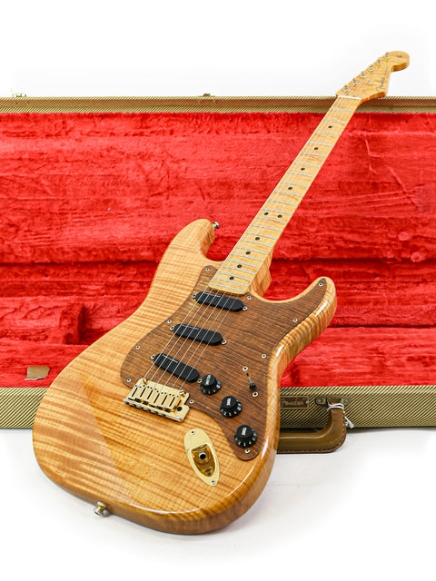 Inside a vibrant red case lies a 1992 Fender Custom Shop 'Clapton' Stratocaster, a testament to exquisite craftsmanship and design.