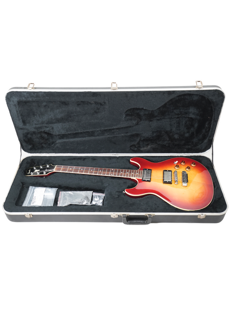 Inside a vintage case, a red Fender Esprit guitar from 1984 stands out, highlighting its unique style and craftsmanship.