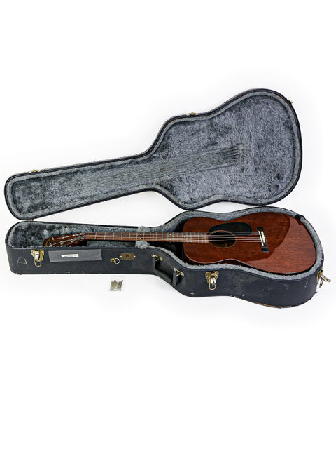 Inside a wooden case lies a 1954 vintage Martin 00-17 guitar, exemplifying elegance and musical heritage.