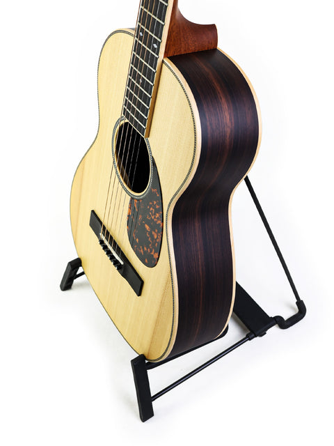 Larrivée 0-40R acoustic guitar from 2016 resting on a stand, showcasing its compact design.