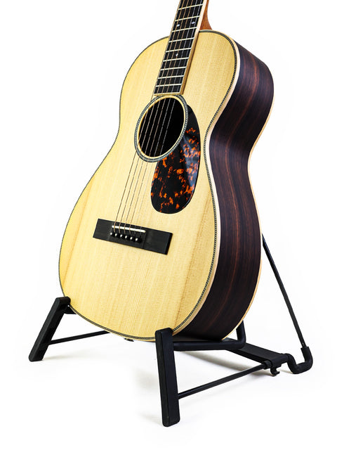Larrivée 0-40R guitar displayed on a stand, set against a bright white background, highlighting its craftsmanship.