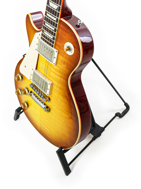 Left-Handed Gibson Custom Shop LPR-8 guitar displayed on a stand, highlighting its unique features and quality.
