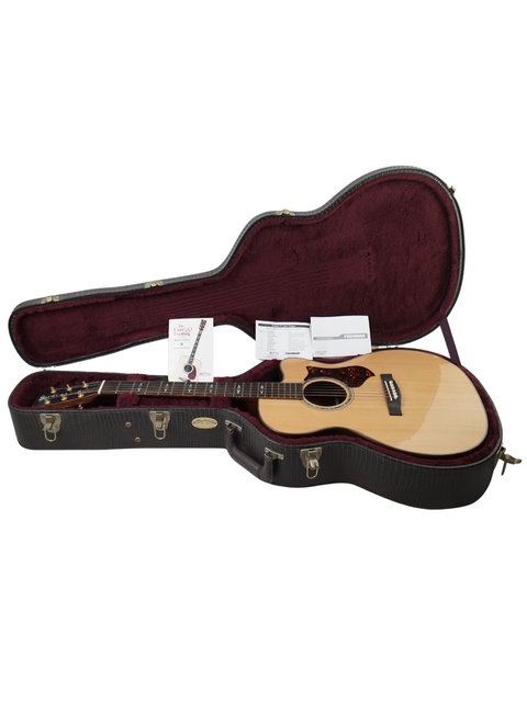 Martin OMC-PA1 guitar nestled inside a sleek guitar case, showcasing its elegant design and craftsmanship from 2011.