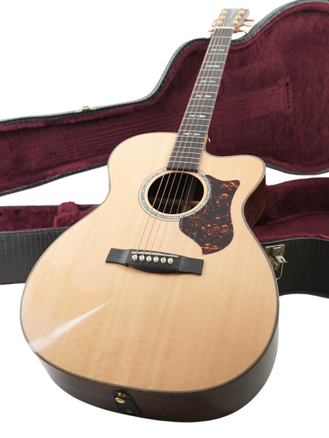 Martin OMC-PA1 guitar securely placed in its case, highlighting the instrument's quality and American craftsmanship from 2011.