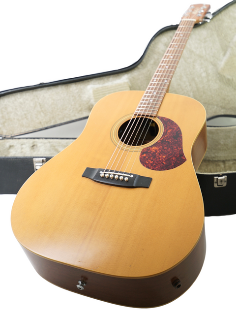 Maton EM300 guitar from 1991 rests in its case against a clean white background, showcasing its natural finish.