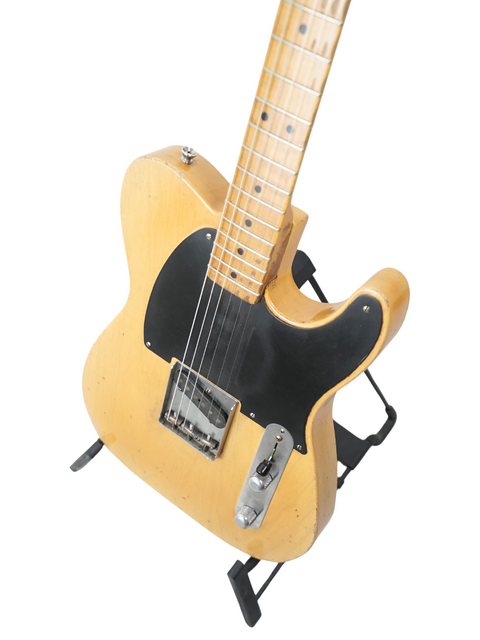 Nacho Guitars' 50s Stratocaster features a wooden body and sleek black pick guard, made in Spain, 2024.
