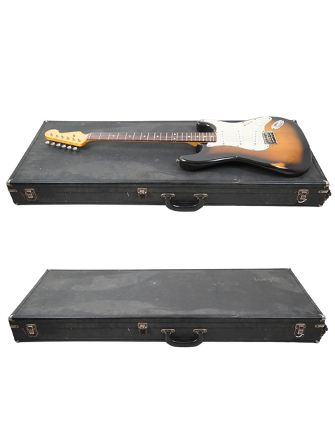 Nash S63 Stratocaster Relic guitar from 2009 and another guitar in a case, set on a clean white background.
