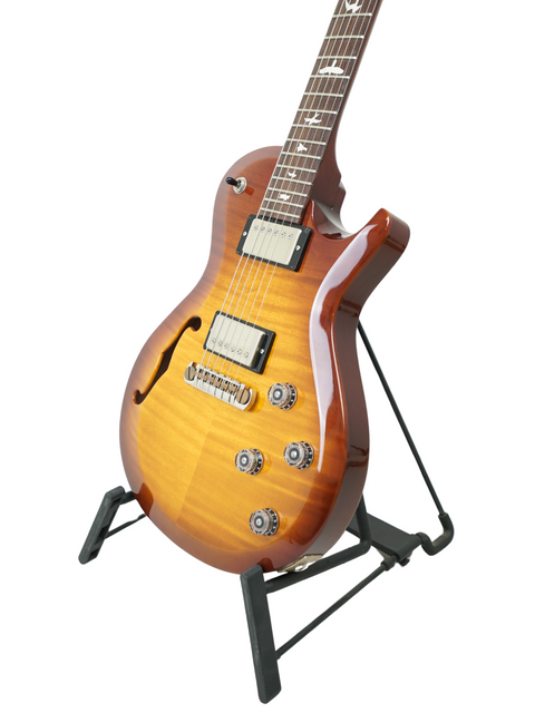PRS S2 Singlecut Semi-Hollow guitar displayed on a stand, set against a bright white background for a striking visual.