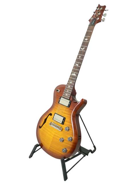 PRS S2 Singlecut Semi-Hollow guitar on a stand against a clean white background, showcasing its elegant design.
