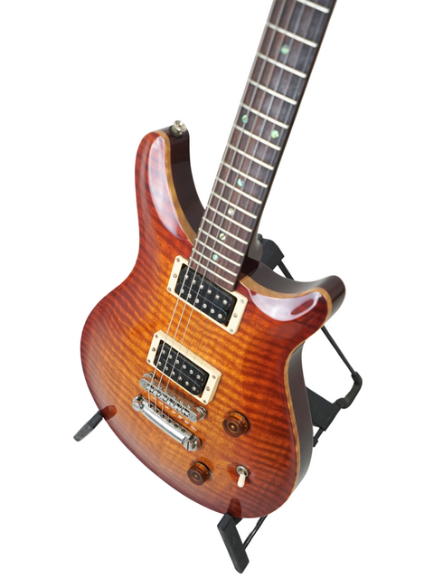 Perspective shot of Belman Double Cut Grand on a stand, showcasing the guitar's craftsmanship and sleek design.