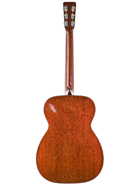 Rear perspective of a 1954 Martin 00-17 acoustic guitar, featuring a beautifully crafted wooden back.

