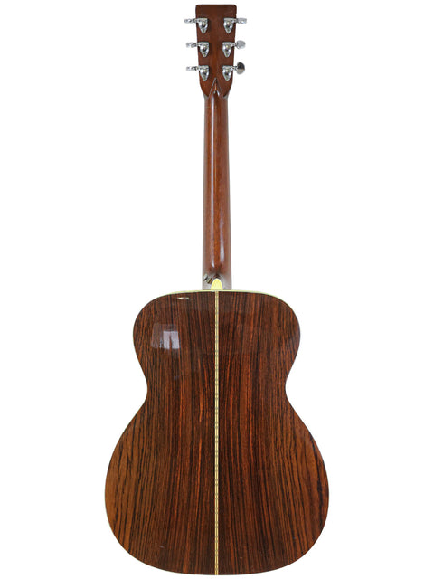 Rear perspective of a 1976 Martin 000-28 acoustic guitar, featuring a beautifully crafted wooden back.