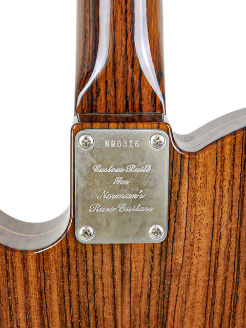 Rear side of a limited edition Fender Telecaster guitar, displaying a metal plate and elegant rosewood craftsmanship.