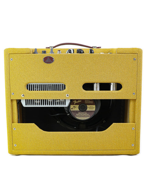 Rear view of a yellow Fender guitar amplifier with visible speaker and controls.