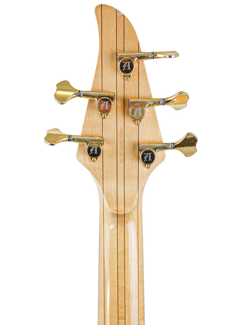 Rear view of the Alembic Orion headstock, showcasing the gold tuners and multi-laminate neck construction.