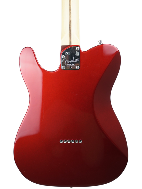 Red Fender electric guitar body with neck, isolated on white background.