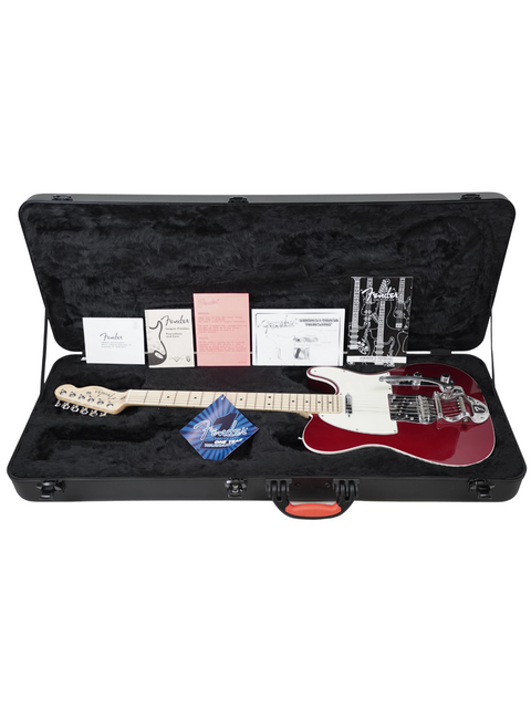 Red and white electric guitar in a black case with various papers and a plectrum.