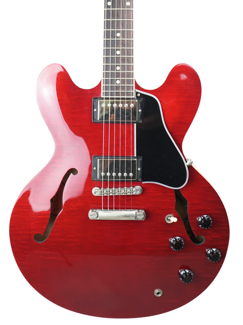 Red electric guitar with a black body, Gibson ES-335 Dot model from USA, 2006, showcasing classic design and craftsmanship.
