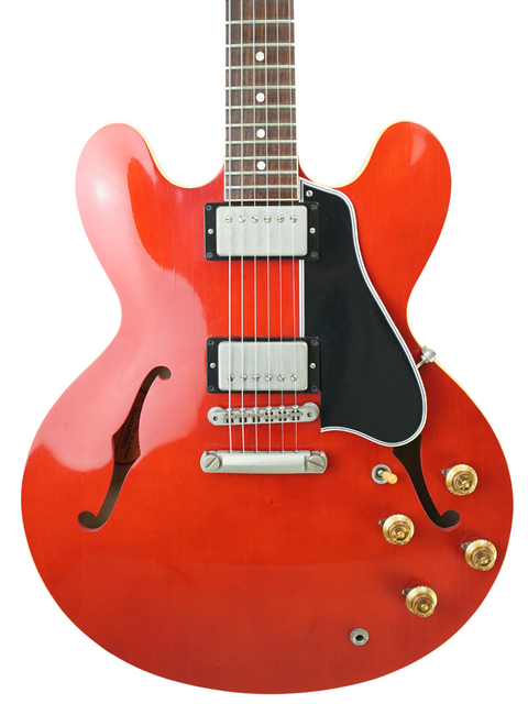 Red electric guitar with a black body, showcasing the Gibson Custom ES-335 Aged '59 Reissue, made in the USA, 2018.
