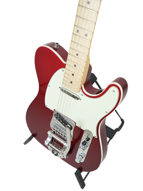 Red electric guitar with white pickguard on a stand, isolated on white background.