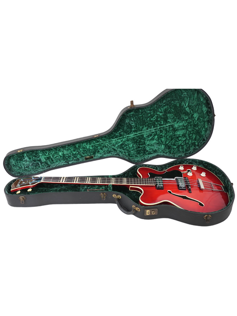 Red guitar case with a green cover, featuring a vintage Hofner Verithin Bass from Germany, dated 1961.