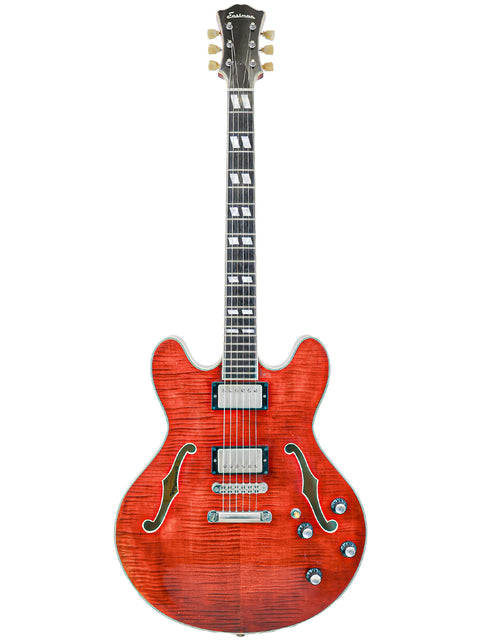 Red semi-hollow electric guitar with f-holes and a sunburst finish.