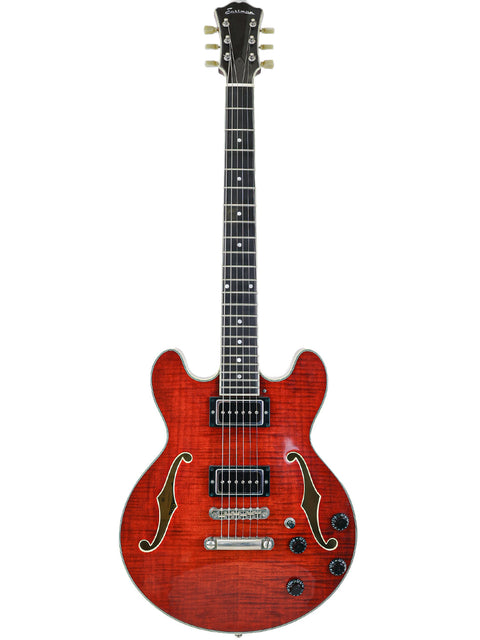 Red semi-hollow electric guitar with f-holes and black pickup on white background.