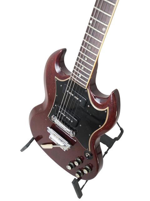 Red vintage Gibson SG Special electric guitar from 1967, featuring a sleek black pick guard, exemplifying iconic style.