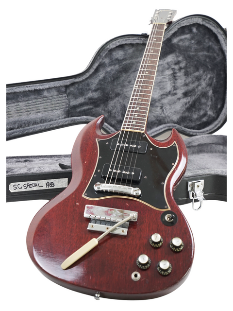 Red vintage Gibson SG Special guitar from 1967, displayed with its case and a guitar pick.