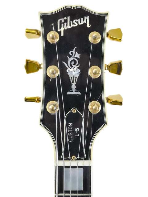 Stunning black Gibson Les Paul Custom Shop guitar, showcasing the L-5 CES James Hutchins Masterlabel, USA, 2002 edition.
