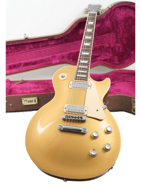 Stunning gold electric guitar, Gibson Les Paul Deluxe Limited Edition 30th Anniversary, securely housed in its case.