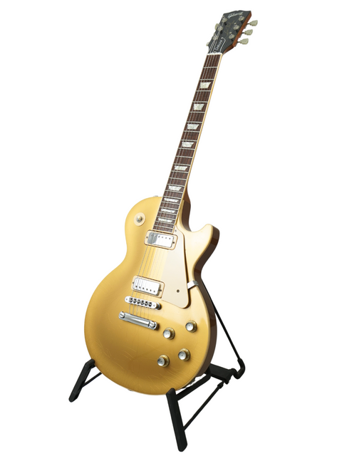 Stunning gold electric guitar on a stand, the Gibson Les Paul Deluxe Limited Edition 30th Anniversary from USA 2000.
