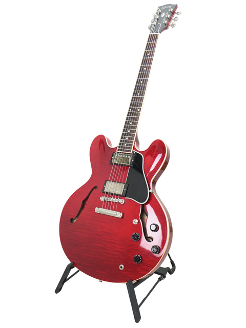Stunning red Gibson ES-335 Dot electric guitar displayed on a stand, highlighting its classic style and craftsmanship.
