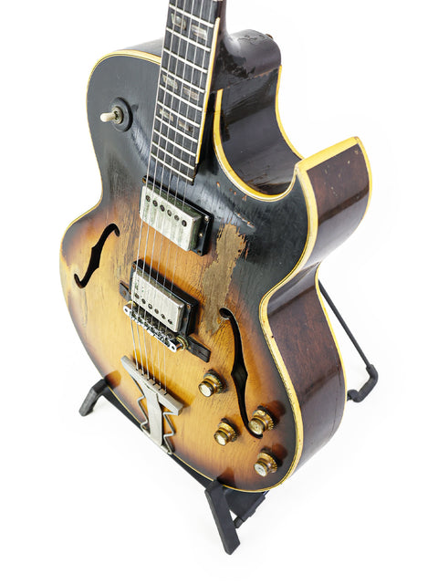 Sunburst-finished 1962 Vintage Gibson ES-175D guitar on a stand, highlighting its timeless beauty.