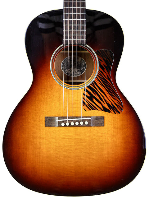 Sunburst acoustic guitar with a dark to light gradient body isolated on a white background.